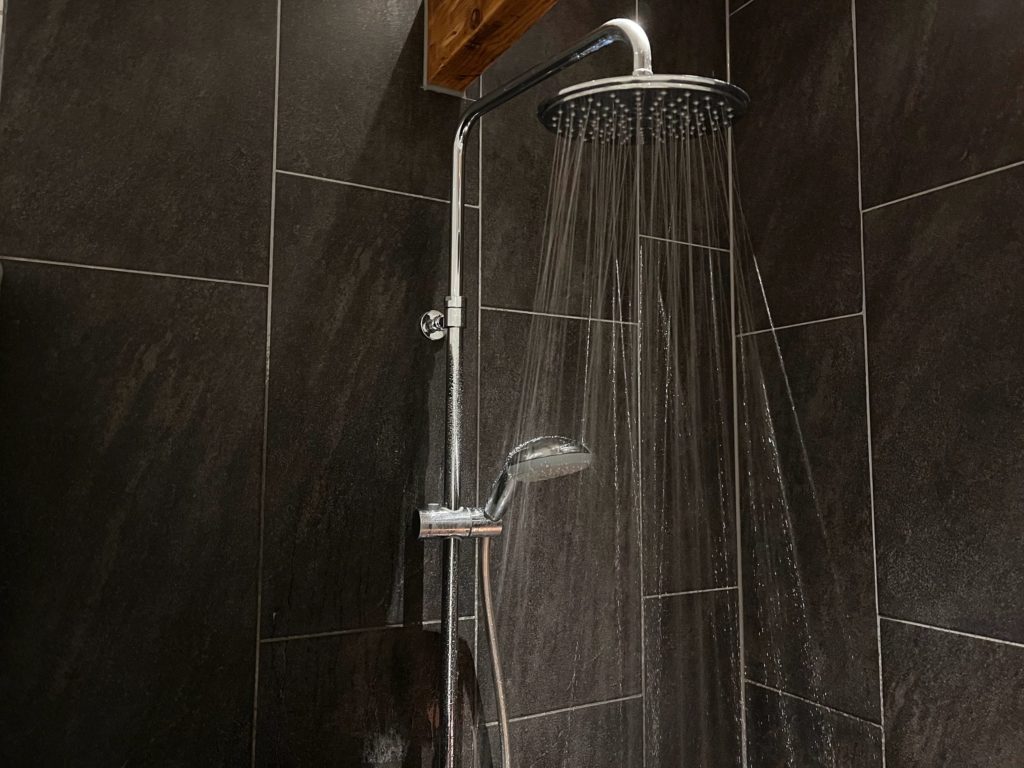 black tile with showerhead