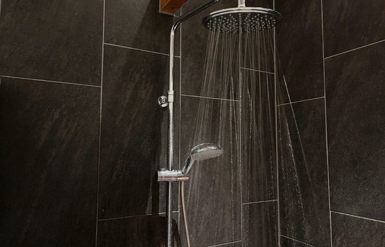 black tile with showerhead