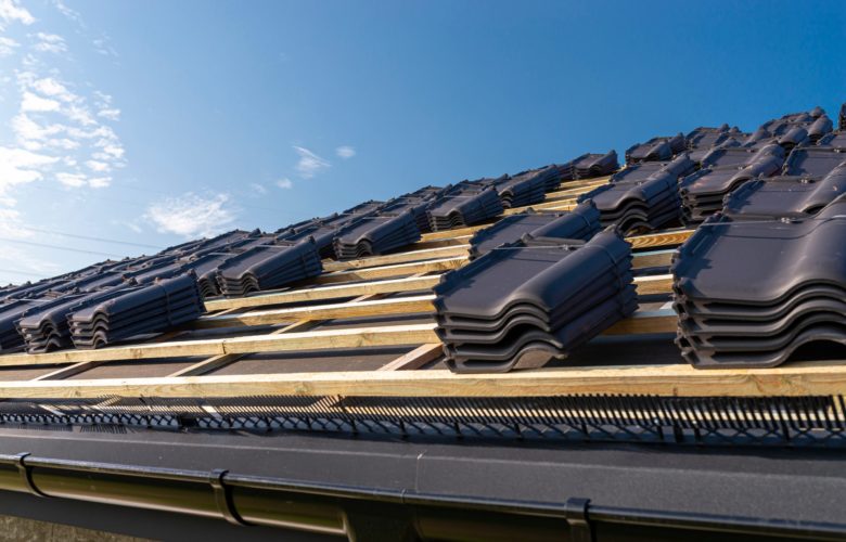 Roof ceramic tile arranged in packets on the roof on roof battens. Preparation for laying roof tiles